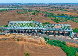 130 m long span of steel bridge launched over Indian railway tracks for Mumbai-Ahmedabad Bullet Train Project